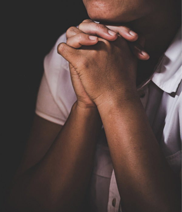 Hands clasped in prayer